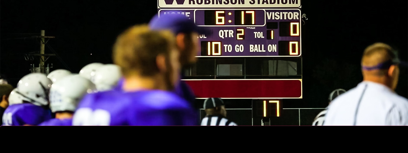 A high school football score board with Ravan City Central Bank  logo.